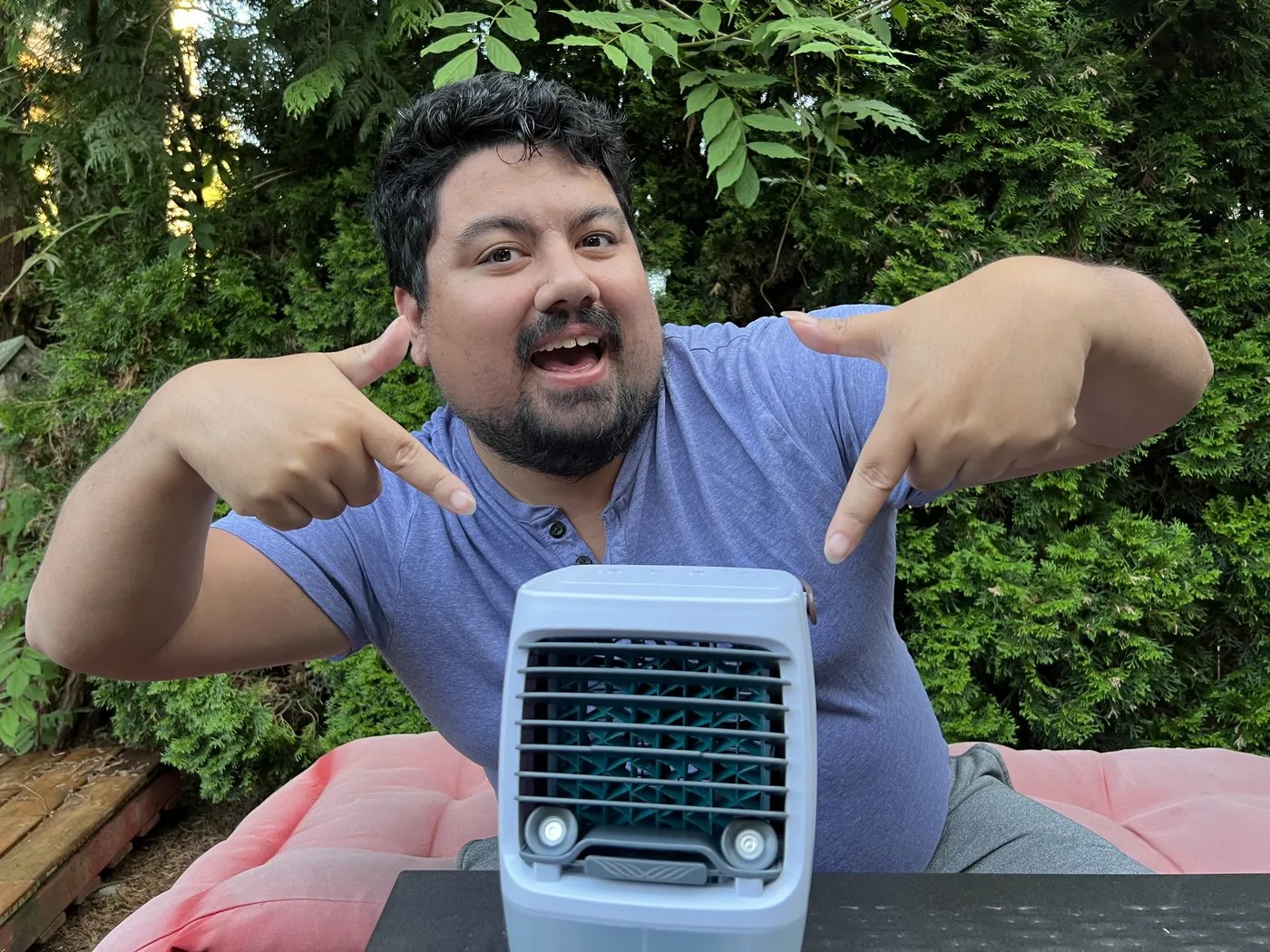 A tester sitting beside the ChillWell 2.0 in a backyard